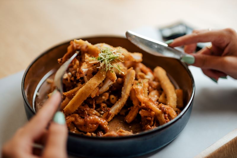 saucy chicken strips with vegetables in a bowl