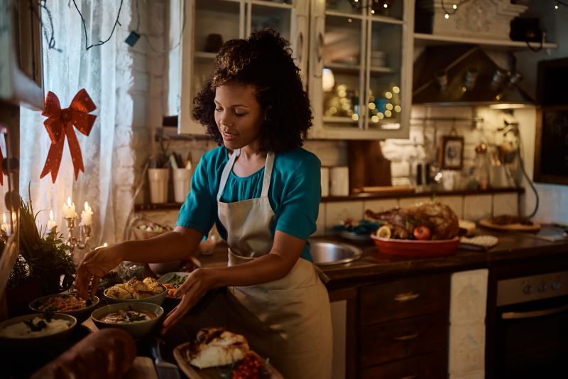 Woman preparing a Thanksgiving dinner for one in her kitchen