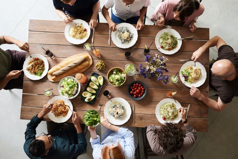 Top-down shot of group of people sharing dinner