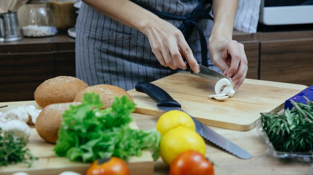 A person cutting a mushroom as an ingredient for an easy light dinner