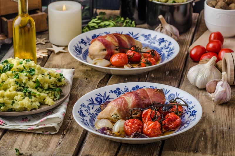 A keto Christmas spread with stuffed chicken breast wrapped in ham