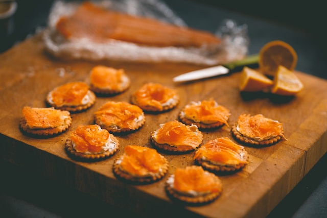 ham and cheese crackers on a wooden serving board