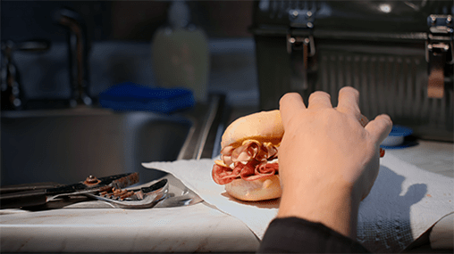 ham sandwich on a paper towel on top of the kitchen counter